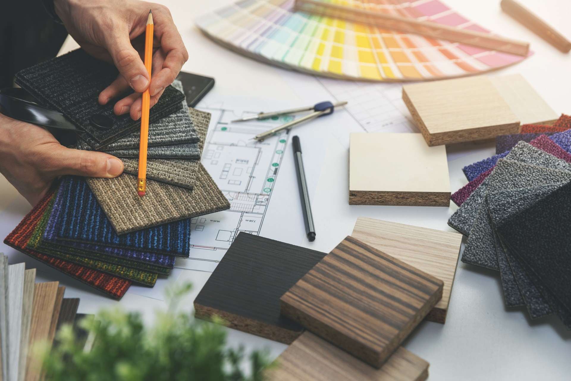 designer choosing flooring and furniture materials from samples for home interior design project